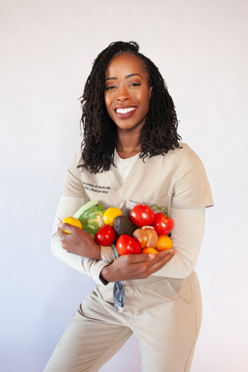 Dr. Christine Adaeze Nwoha, MD holding fresh vegetables